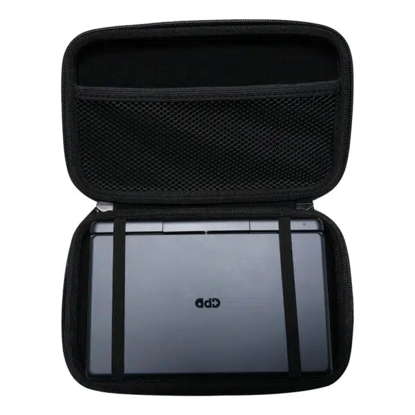 A top-down shot of the open, black hard shell case for the GPD MicroPC 2. A grey GPD MicroPC 2 is secured inside the bottom half with two black elastic straps. The top half of the case has a mesh pocket. The front of the MicroPC 2 is facing upwards, showing the "GPD" logo.
