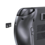 A close-up, angled shot of the back of a dark grey GPD WIN 5 handheld gaming console against a plain white background. The image focuses on the microSD card slot, which has a 2TB microSD card being partially inserted into it. The textured back grip and the "R4" shoulder button are also visible.