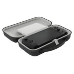 An angled, open view of the black carrying case. The interior is light grey, and a black GPD WIN 5 console is secured inside the bottom half with a white strap. A solid white protective screen cover/divider is over the device, and the top half of the case is empty. The case features an integrated carrying handle.