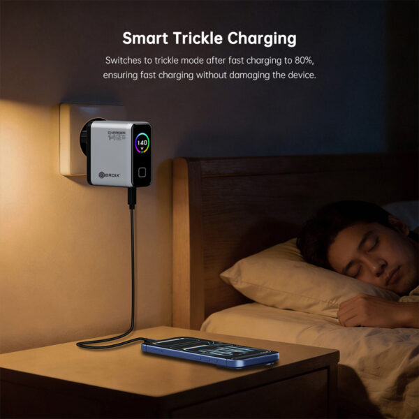 Wall-mounted smart charger beside a bed, with a phone charging on the nightstand.