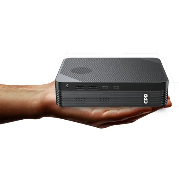 Black GPD BOX GPD Mini PC in front angle on an open hand, ribbed top, rounded edges and visible USB ports