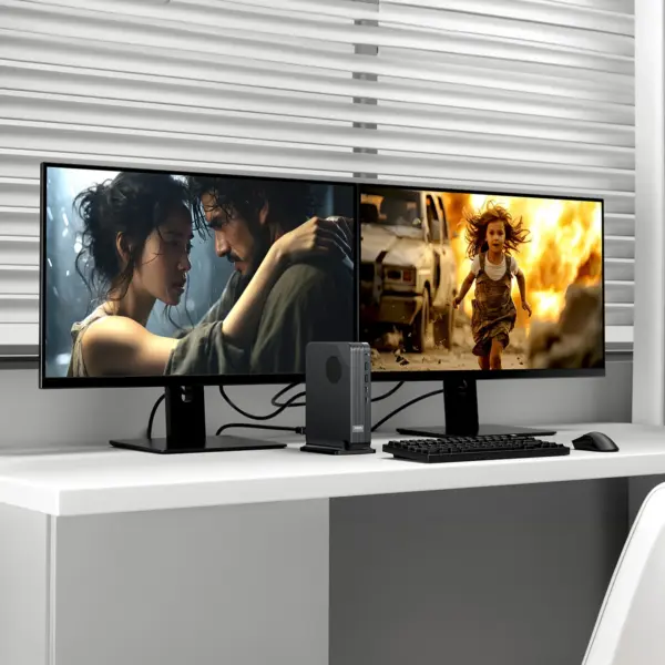 Front view of black textured GPD BOX Mini PC on stand between dual monitors, keyboard and mouse on white desk