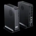 GPD BOX Mini PC pair in matte black, angled on stands with ribbed vents, USB ports and rear Ethernet visible